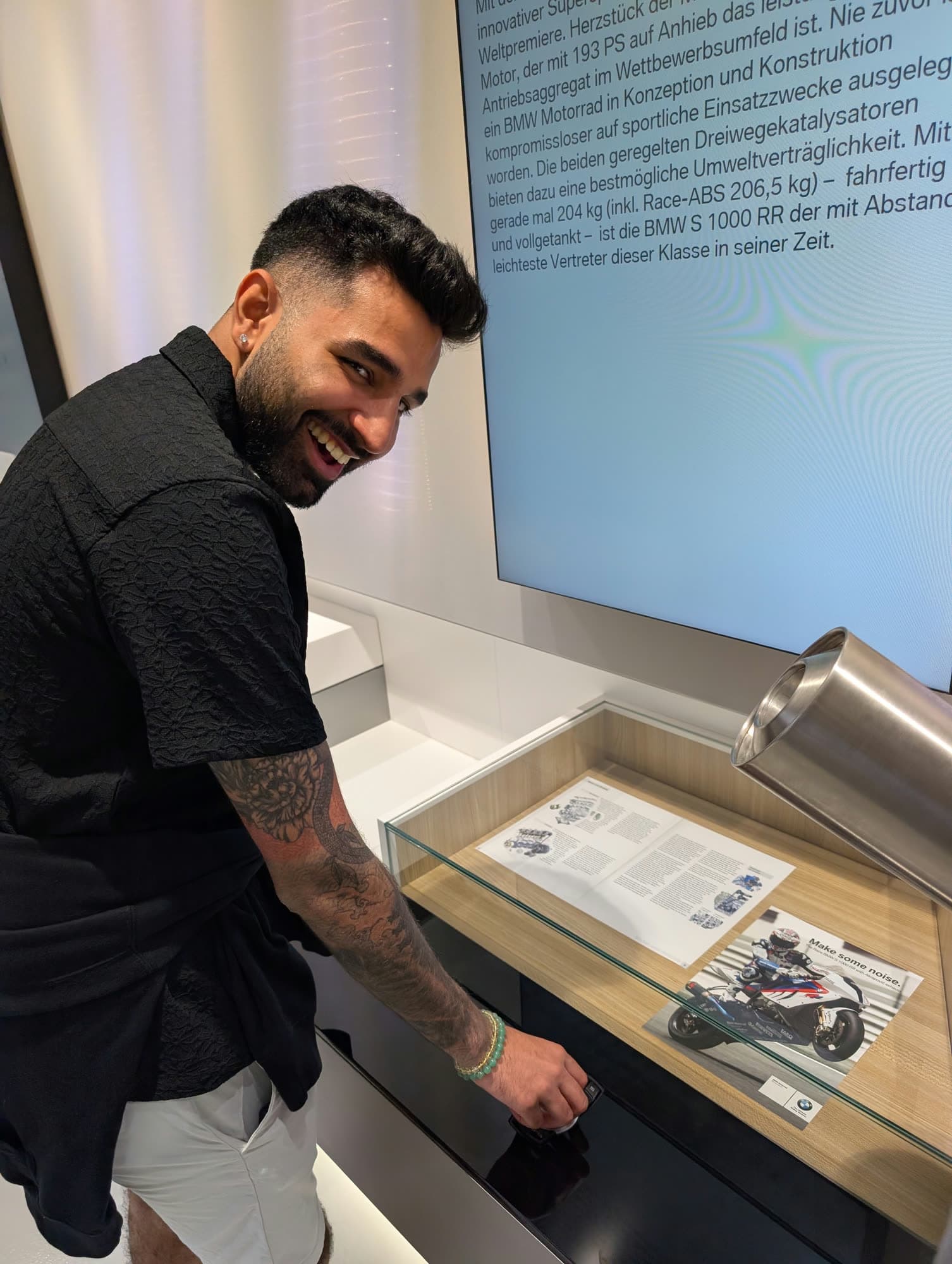 Me looking back at the camera, laughing, hand on the display case