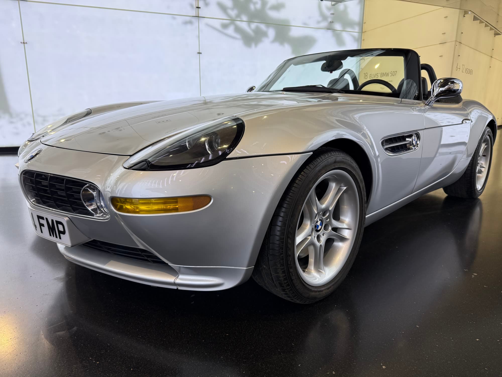 A silver BMW Z8 roadster, front three-quarter view, under museum lights