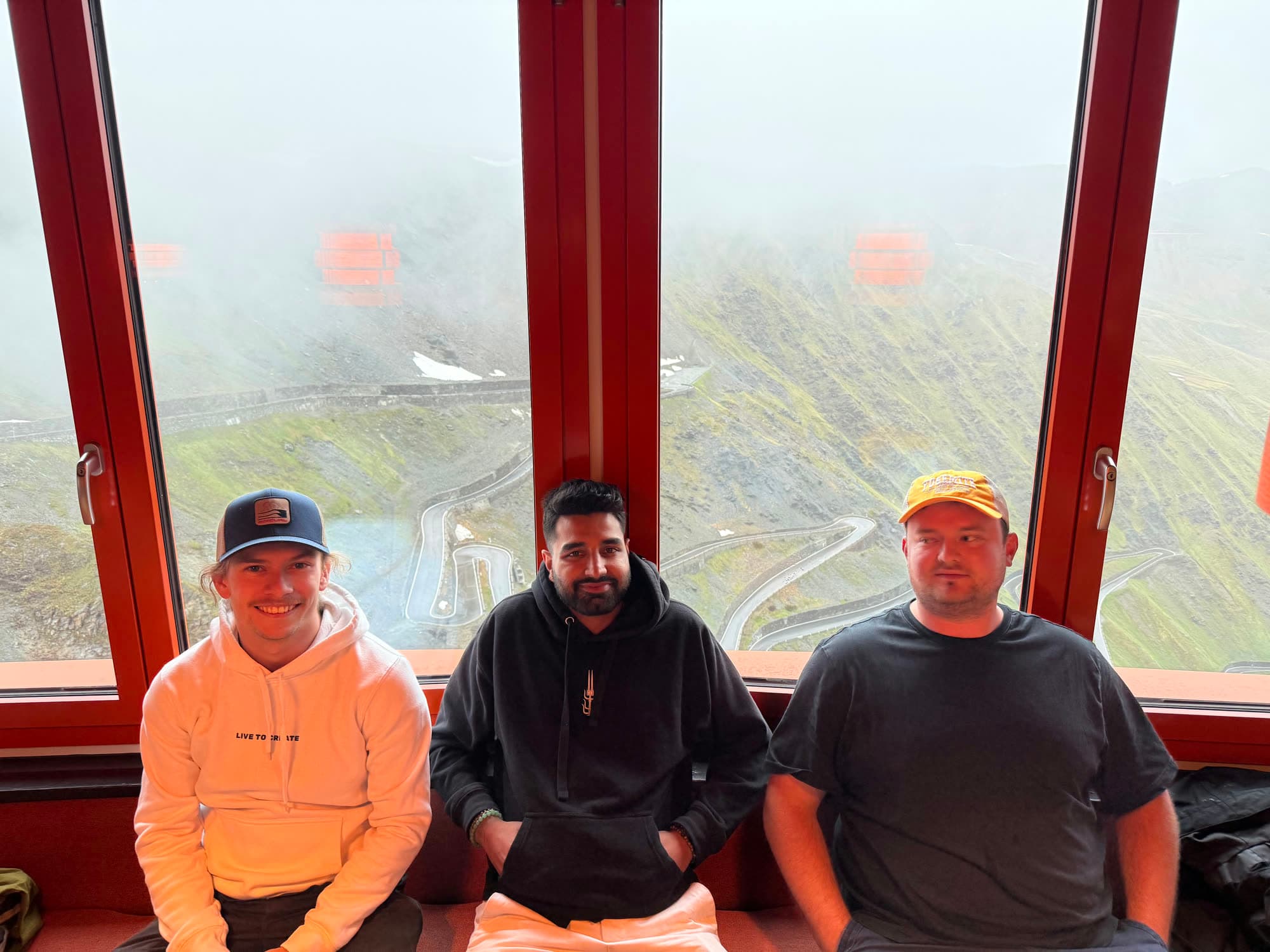 Three of us seated at a window table, fog over the switchbacks behind
