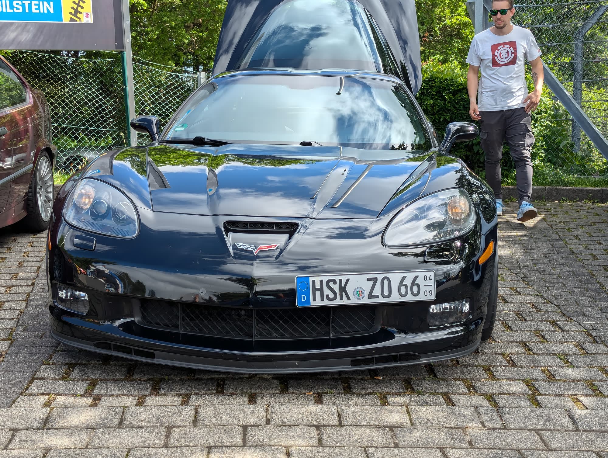 Black Corvette C6 in the Nürburgring paddock, Bilstein banner overhead