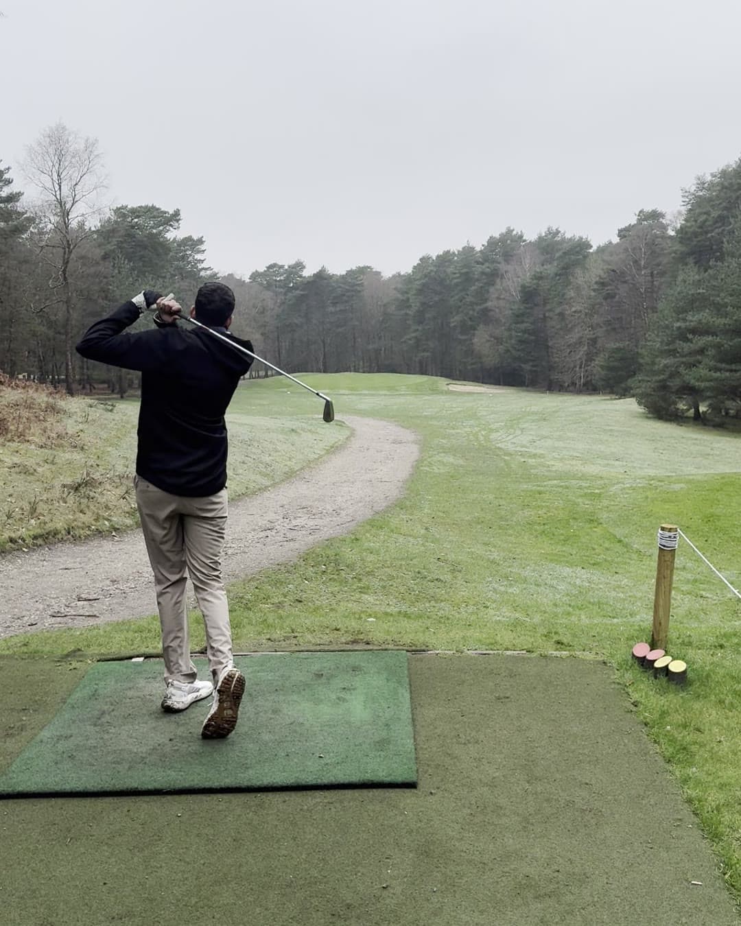 Param from behind in a high finish, club over his shoulder and his back heel up, looking down the fairway