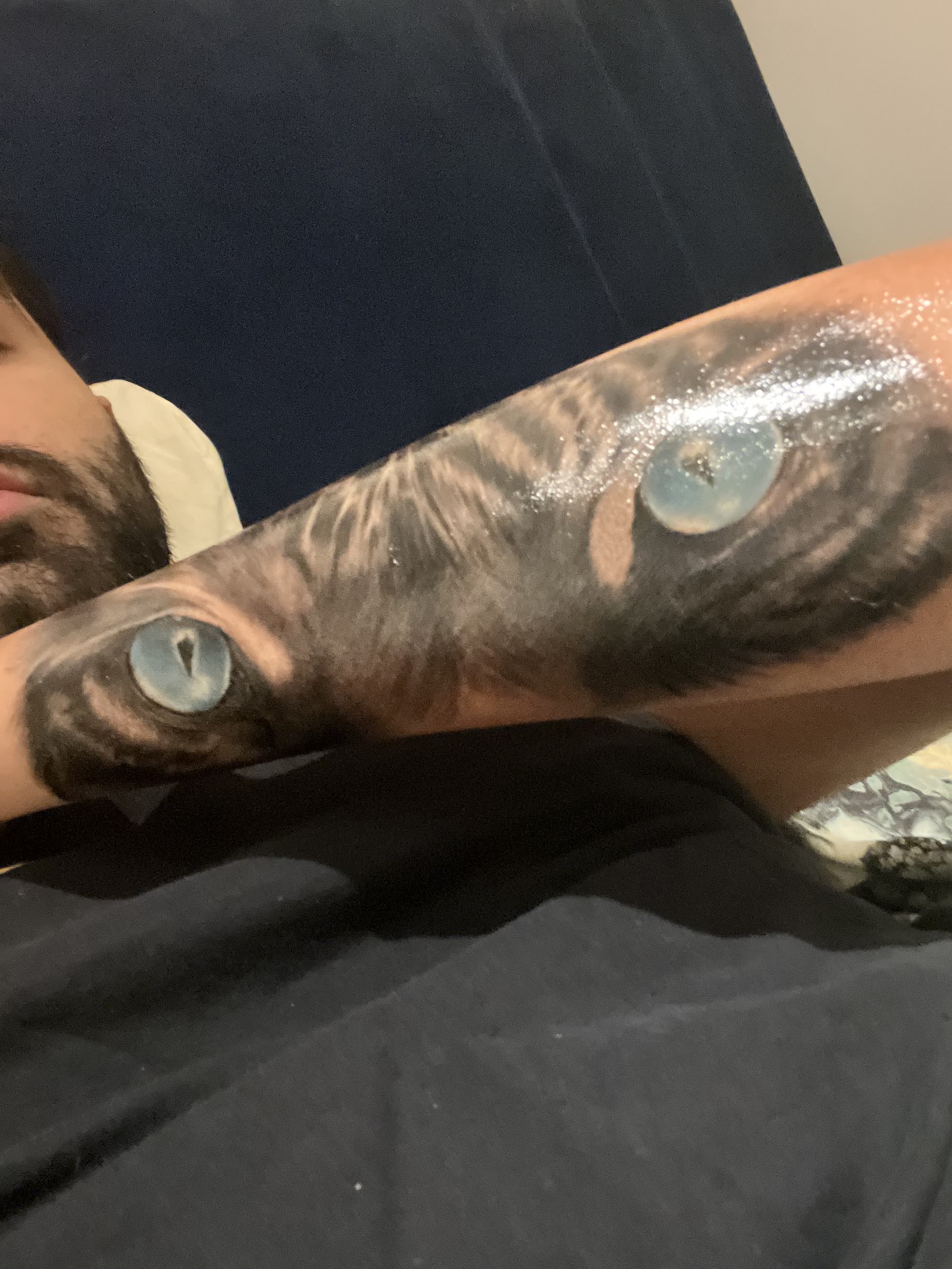 Tiger eyes — hyper-realistic blue irises on inner forearm
